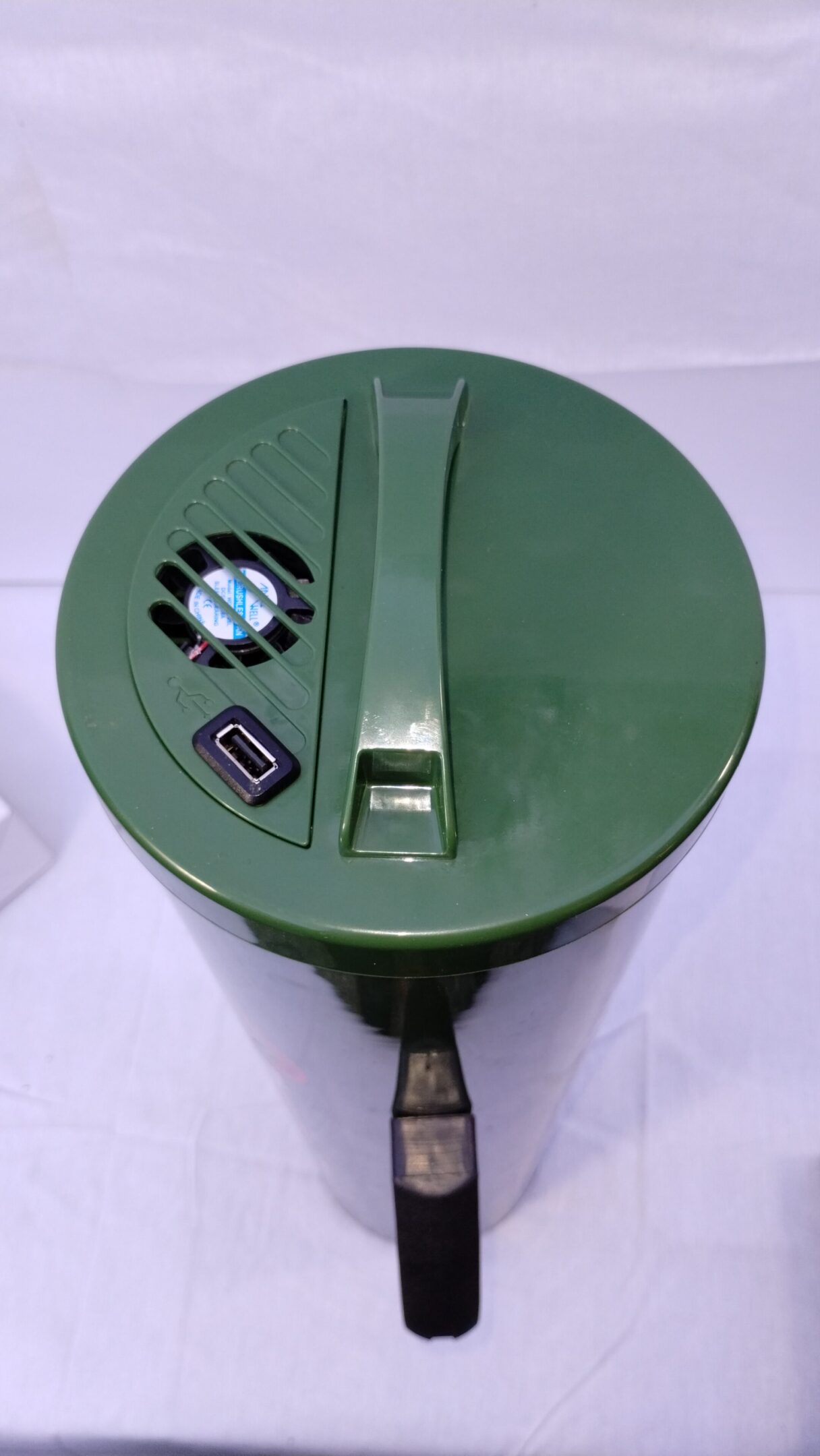 Green vintage camera with a unique dial and handle on a white background.