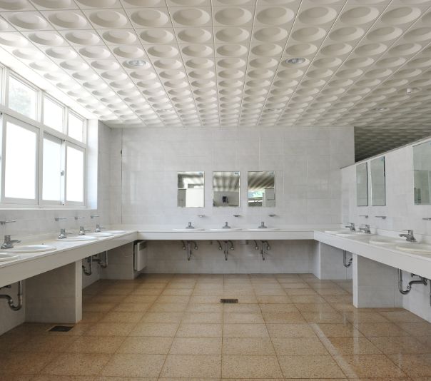 Empty, spacious restroom with multiple sinks and mirrors.