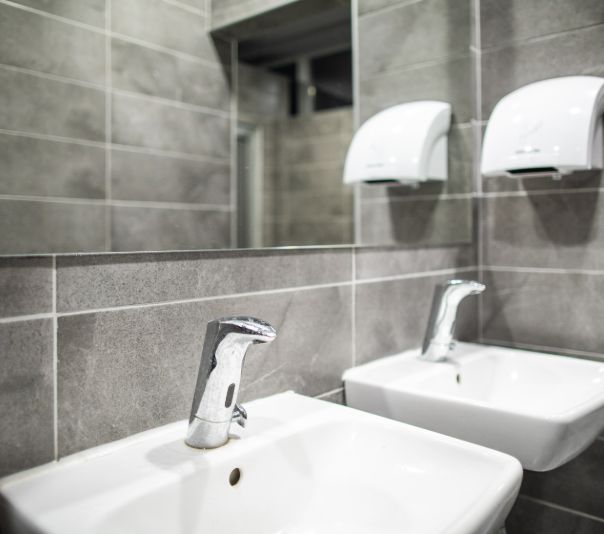 Modern bathroom sink with sleek faucet and mirror.