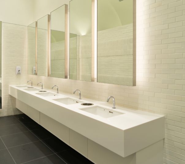 Modern restroom with sleek sinks and large mirrors.