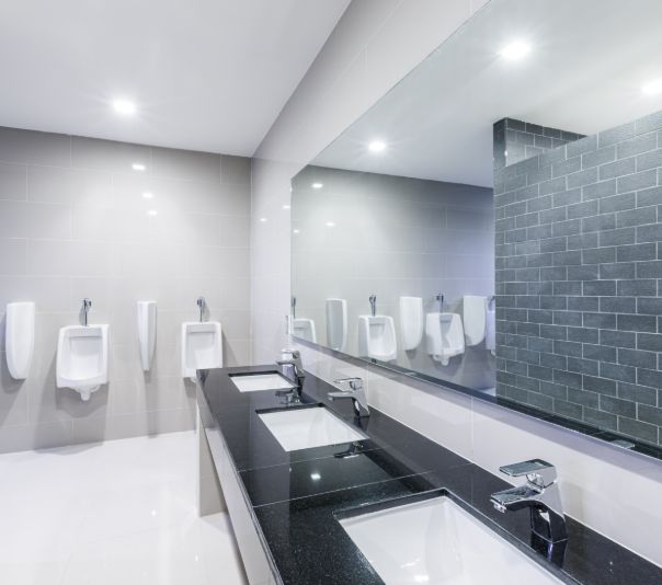 Modern public restroom with sinks and urinals.