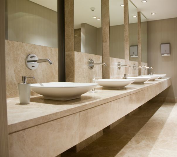Modern bathroom sinks with sleek faucets and large mirrors.