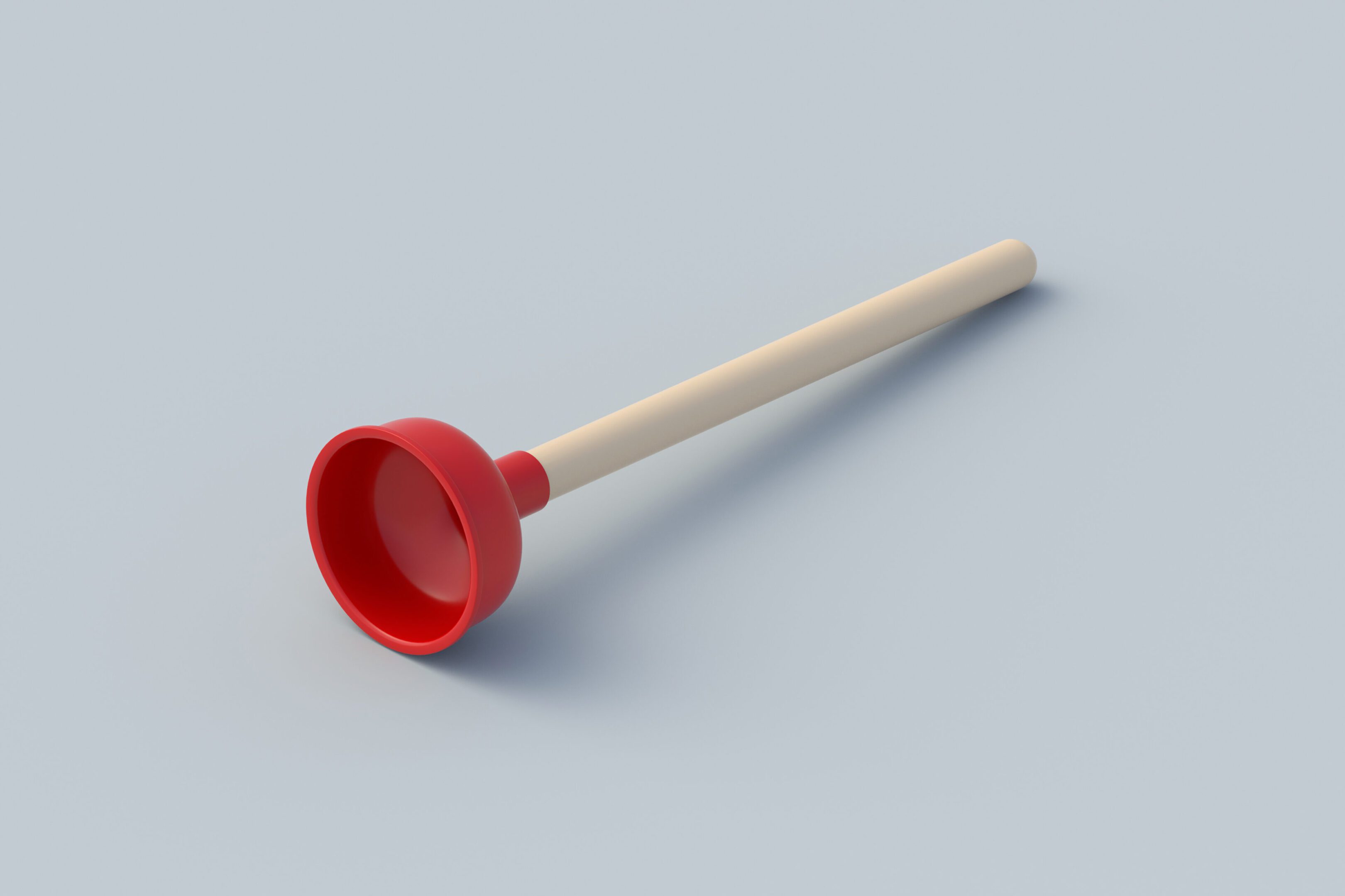 Red and beige plunger on gray background.