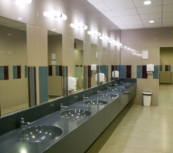 Modern public restroom with multiple sinks and mirrors.