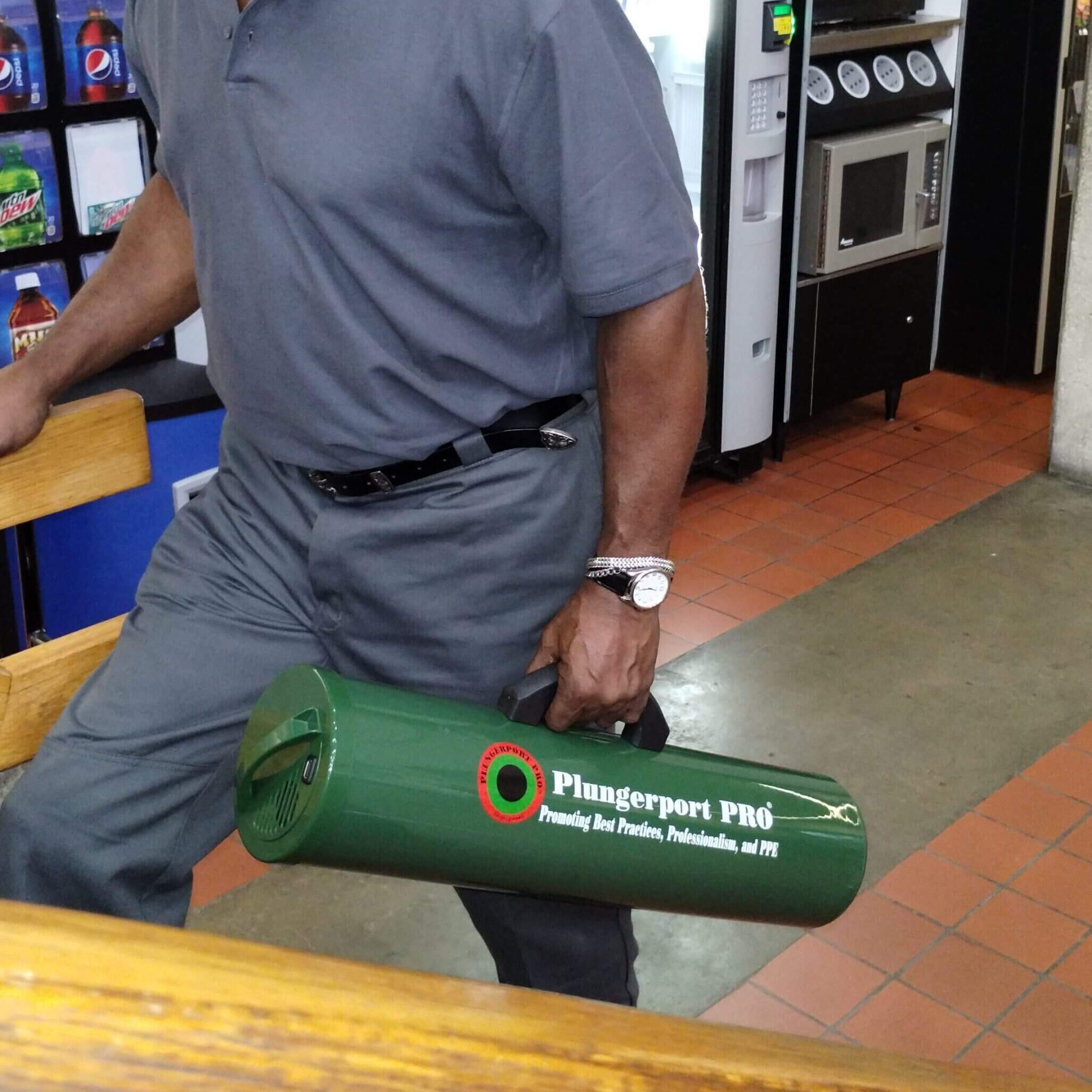 A man holding a green cylindrical object in a store.